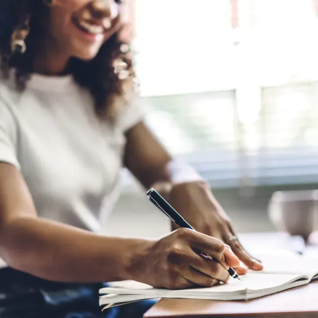 Professional writing notes at a desk