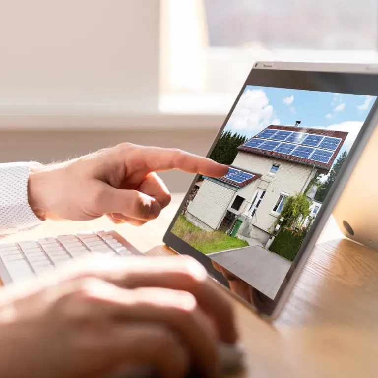 Hands reviewing a real estate listing on a tablet