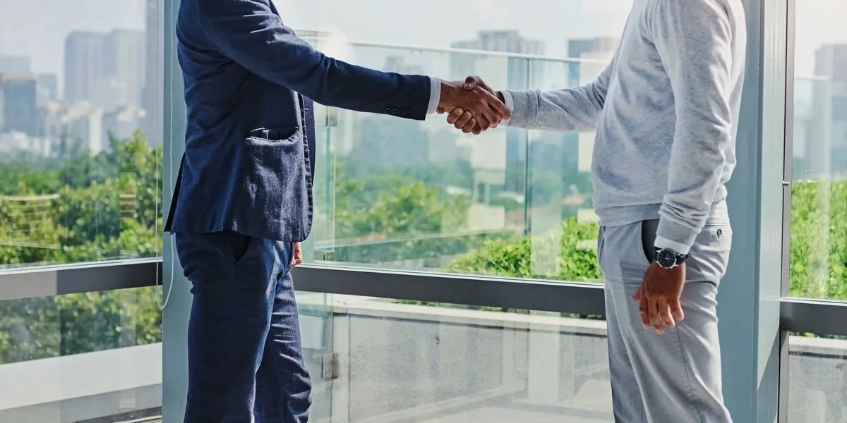 Real estate professionals shaking hands in agreement